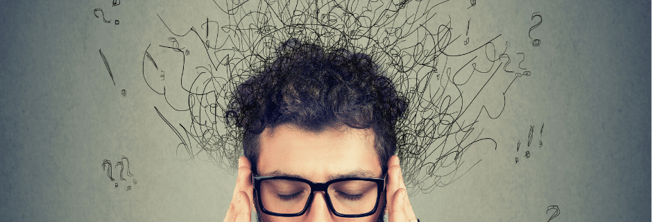 Man touches his temples clearly struggling with anxiety