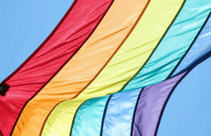 Rainbow pride flag gently waving in the breeze, symbolizing LGBTQ+ inclusion and support.